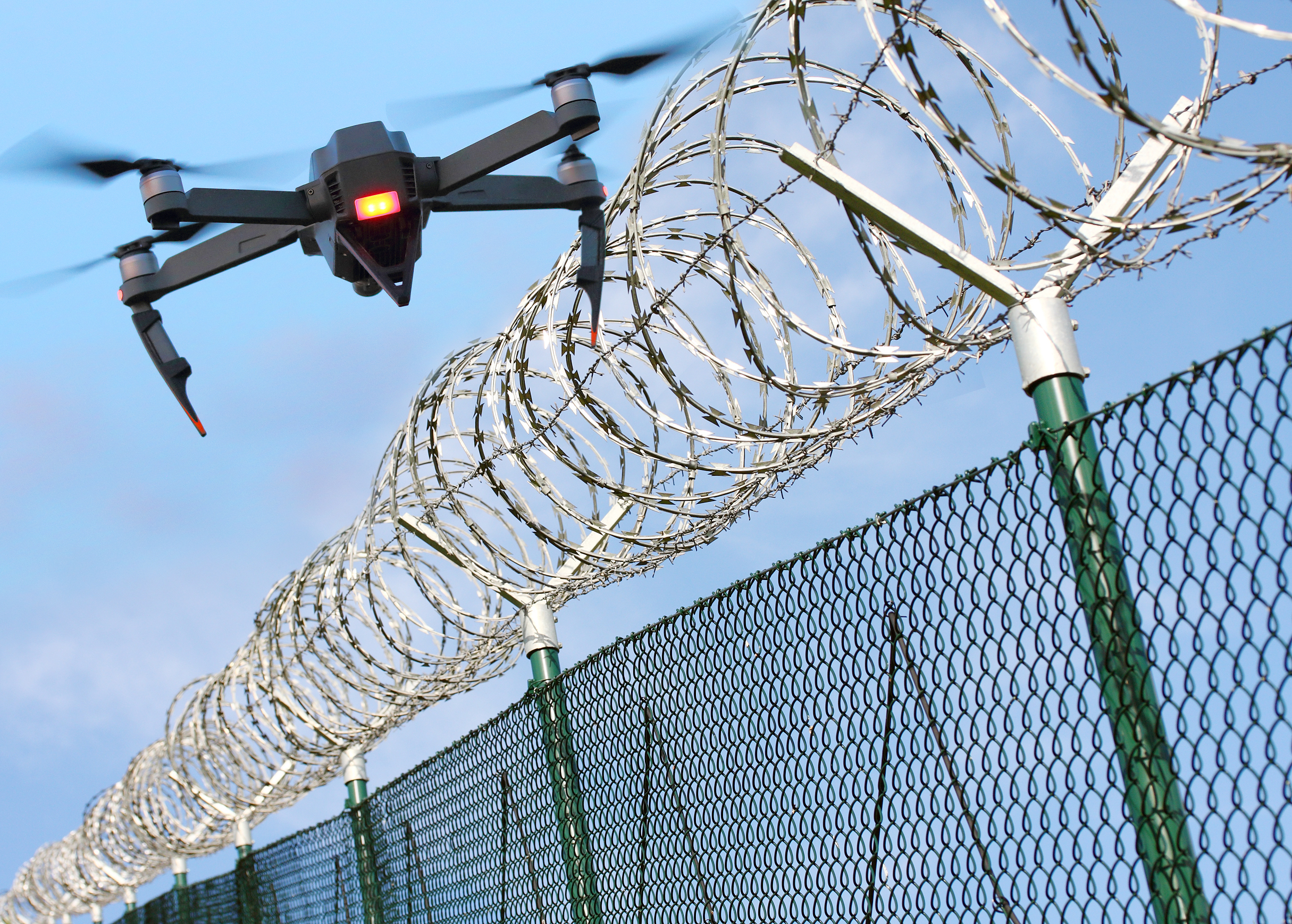 Drone hovering over fence