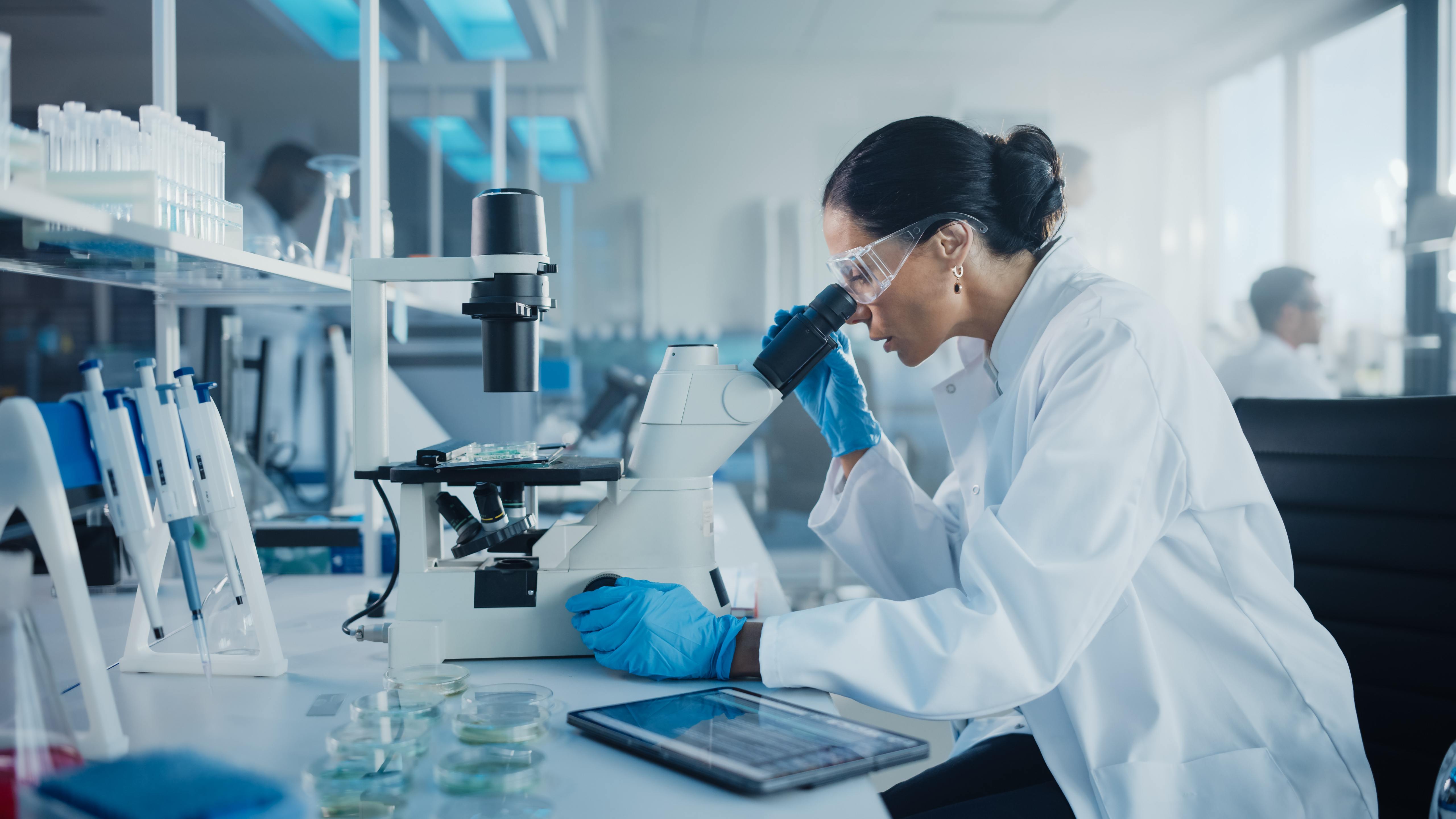 Woman looking on a microscope